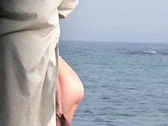 Spying on various naked bimbos on the public beach all day long