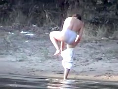 Curvaceous slug receiving two massive cock on the nudist beach
