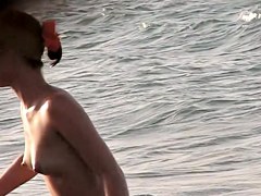 Topless girl playing on the beach and getting voyeured
