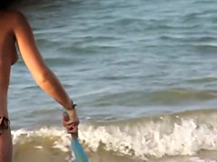 Topless girl playing on the beach and getting voyeured