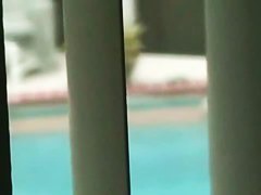 Gorgeous blonde with juicy tits swims completely naked in the pool by the beach