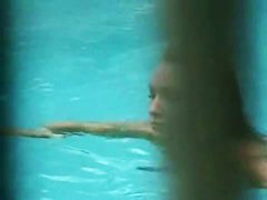 Gorgeous blonde with juicy tits swims completely naked in the pool by the beach