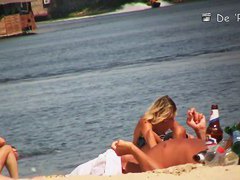 A shy fox with a seductive body stands slim on a beach in a porno