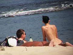 A shy fox with a seductive body stands slim on a beach in a porno