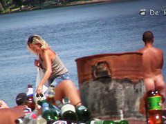 A shy fox with a seductive body stands slim on a beach in a porno