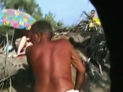 Middle aged couple having oral sex on the beach