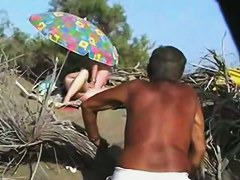 Middle aged couple having oral sex on the beach