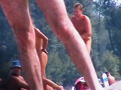 Adults taking sunbaths and relaxing on the nude beach