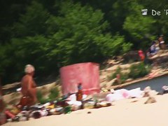 Flat chested brunette and mature blonde on beach voyeur vid