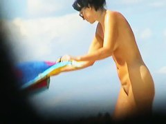 Cute couple is having a rest on the beach naked