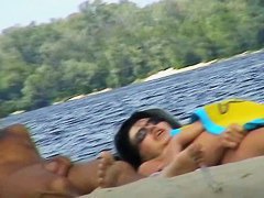Cute couple is having a rest on the beach naked