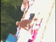 Smooth ass babes on the beach are showing their boobies