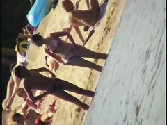 Smooth ass babes on the beach are showing their boobies