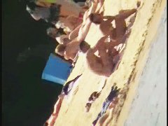 Smooth ass babes on the beach are showing their boobies