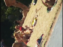 Smooth ass babes on the beach are showing their boobies