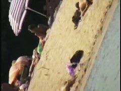 Smooth ass babes on the beach are showing their boobies