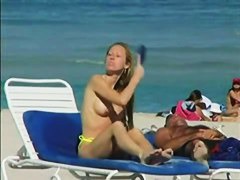 Topless beach voyeur shots of cute girls relaxing themselves