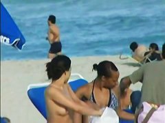 Topless beach voyeur shots of cute girls relaxing themselves