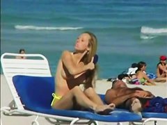 Topless beach voyeur shots of cute girls relaxing themselves