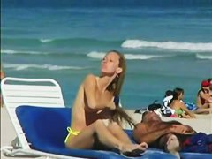 Topless beach voyeur shots of cute girls relaxing themselves