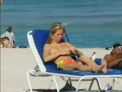Topless beach voyeur shots of cute girls relaxing themselves