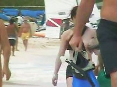 Various females on the beach tanning in a porno compilation