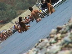 lots of very sexy naked babes on the nudist beach getting wet