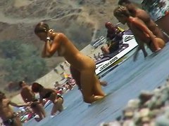 lots of very sexy naked babes on the nudist beach getting wet