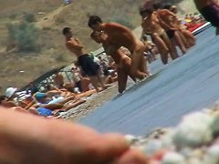 lots of very sexy naked babes on the nudist beach getting wet
