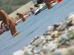 lots of very sexy naked babes on the nudist beach getting wet