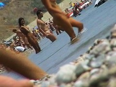 lots of very sexy naked babes on the nudist beach getting wet