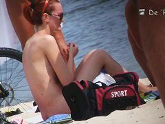 Wonderful babes are sitting on the beach and oiling themselves