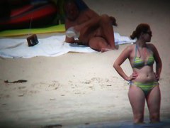 Nude beach voyeur spies on a perky breasted blonde