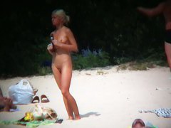 Nude beach voyeur spies on a perky breasted blonde
