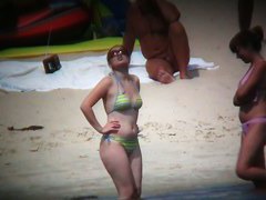 Nude beach voyeur spies on a perky breasted blonde
