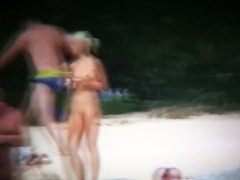 Nude beach voyeur spies on a perky breasted blonde