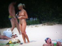 Nude beach voyeur spies on a perky breasted blonde