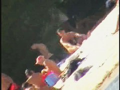 a voyur porno of a sexy blonde chick sitting tanning on a beach