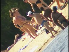 a voyur porno of a sexy blonde chick sitting tanning on a beach