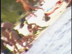 a voyur porno of a sexy blonde chick sitting tanning on a beach