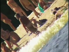 a voyur porno of a sexy blonde chick sitting tanning on a beach