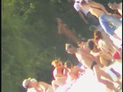 a voyur porno of a sexy blonde chick sitting tanning on a beach