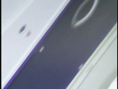 a voyur porno of a sexy blonde chick sitting tanning on a beach