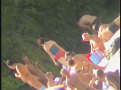 a voyur porno of a sexy blonde chick sitting tanning on a beach