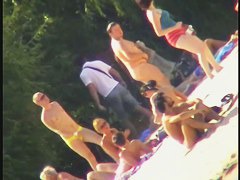 a voyur porno of a sexy blonde chick sitting tanning on a beach