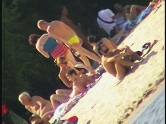 a voyur porno of a sexy blonde chick sitting tanning on a beach