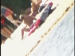 a voyur porno of a sexy blonde chick sitting tanning on a beach