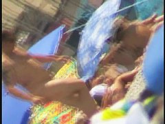 Nudist video at the beach has shy girl playing in the water