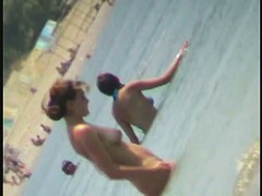 Nudist video at the beach has shy girl playing in the water