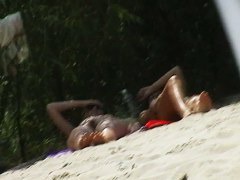 A nudist beach video with big dome tits and hairy pussies